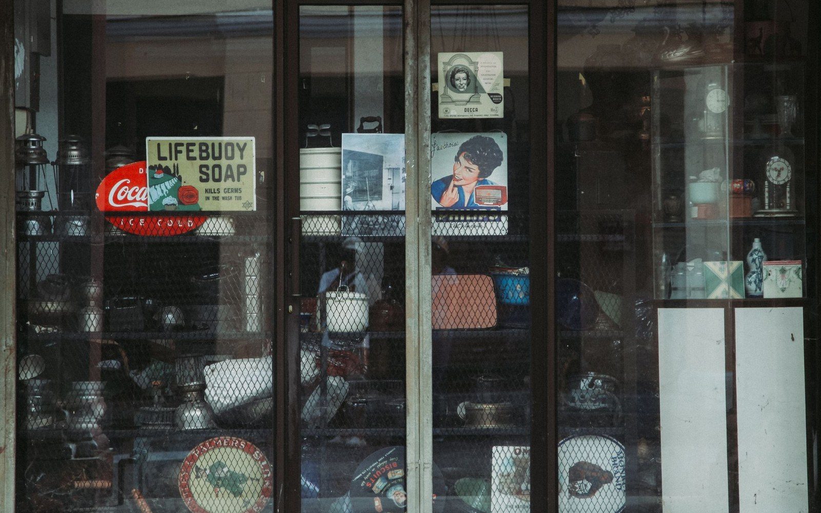 A papered shopfront window on Franklin Street, straight on, the previous tenant's decal still on the glass